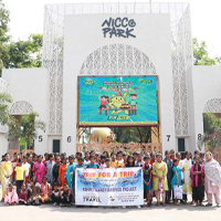 The children and staff pose infront of the park entrance